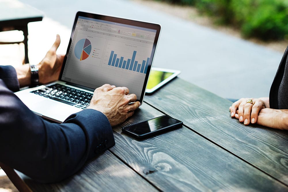 Um advogado analisando um gráfico na tela de um notebook, demonstrando a importância da análise financeira